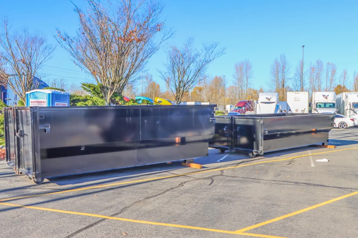 Professional dumpster rental service with roll-off container on residential driveway in Oceola